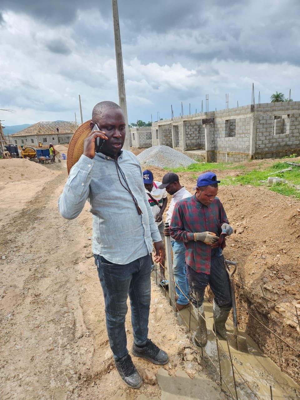 Site supervisor overseeing foundation concrete pour on a residential estate development