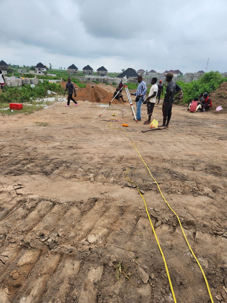 Survey team setting up a total station on an estate access road
