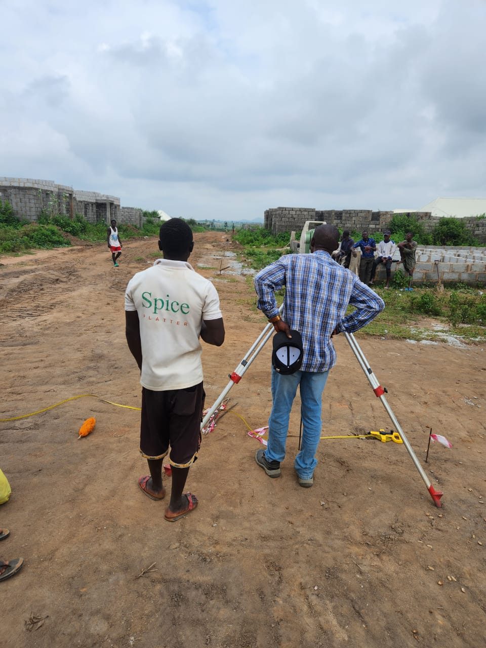 Survey team taking readings along an estate access road